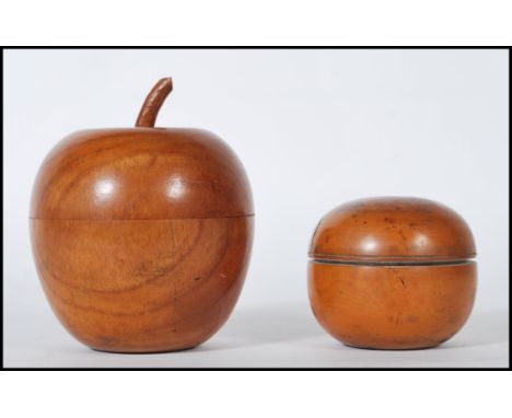 A 20th Century carved wood tea caddy in the form of an apple together with an olive wood dressing table pot ob bulbous form h