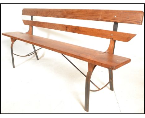 A 20th Century Victorian style pine station bench, raised on upright metal supports with plank seat pad and backrest. Measure