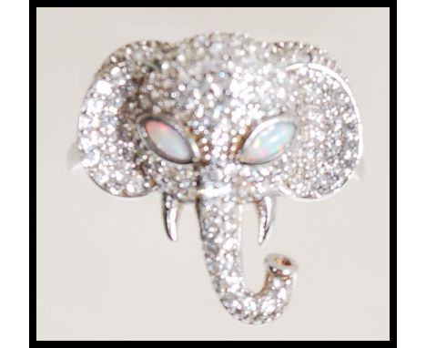 A stamped 925 silver ring in the form of an elephants head set with Cz's and opal eyes. Ring size P. Gross weight 5.4g.&nbsp;