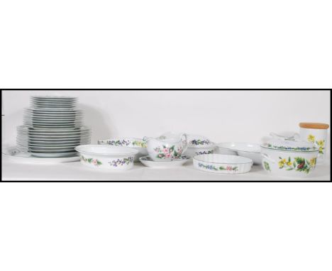 A large 20th Century Royal Worcester dinner service in the Herbs pattern, each piece being decorated with different botanical