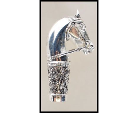 A silver walking stick handle in the form of a horse having floral decorated collar with a central monogrammed cartouche. Sta