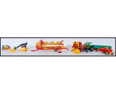 A collection of assorted Britains Farmyard vehicles and accessories to include Vermeer Round Baler, New Holland Hay Baler, 8 