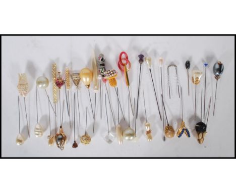 An assortment of vintage 20th Century hat pins to include a Scottish thistle finial hat pin, simulation pearl hat pins, beade