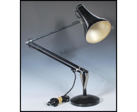 A vintage 20th Century Herbert Terry Anglepoise industrial desk lamp finished in black enamel colourway. Raised on circular b