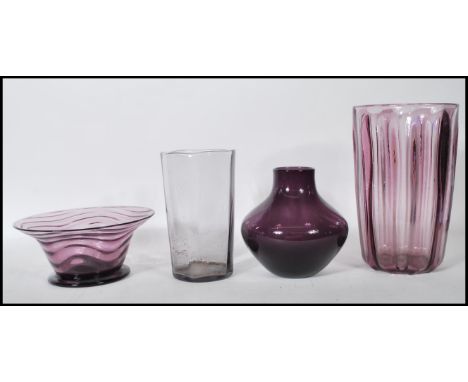 A selection of mid 20th Century retro amethyst purple glass to include a footed bowl of flared form with a wave design, two c