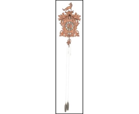 A Black Forest cuckoo clock, surmounted by a fox above carved leaf design above the architectural carved chalet case,&nbsp;Ro