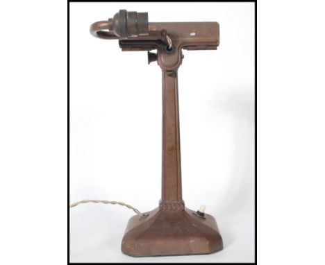 An early 20th Century Art Deco desk lamp / viewing lamp, shaped base with column upright having clamp and adjustable light.