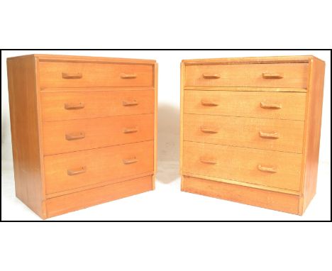 E. Gomme- G Plan- Brandon Range- A matching pair of 20th Century light oak chest of drawers. Each chest consisting of four st
