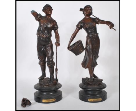 A pair of 19th Century high Victorian bronzed spelter figures modelled as a male and female farm worker with tools, raised on