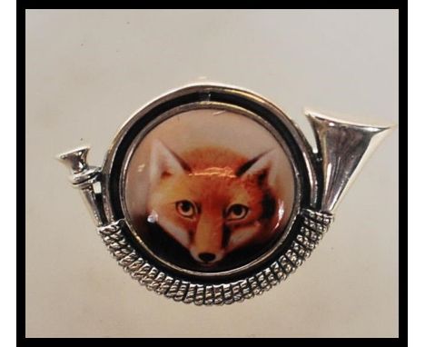 Hunting interest- A silver stamped 925 brooch pendant having a central enamelled panel depicting a fox with the mount in the 