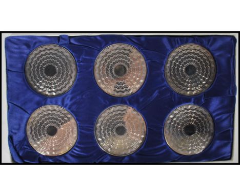 A silver hallmarked set of boxed coasters with engine turned decoration. Hallmarked for Birmingham, date letter X 1972 by WI 