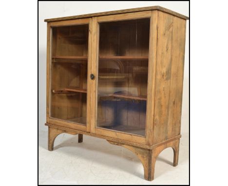 A 19th Century Victorian Industrial office library glazed scrubbed pine bookcase. The reeded edge flared top over full length