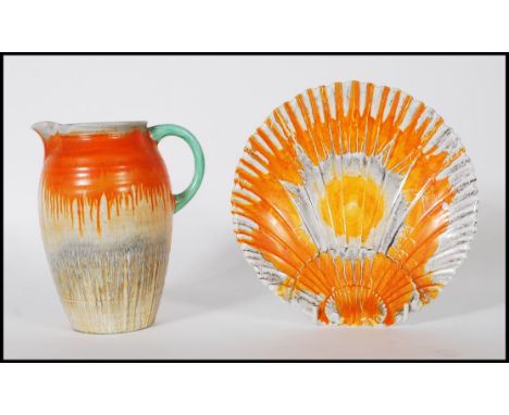 A 1930's Art Deco Shelley ceramic side plate in the form of a scallop shell having an orange and grey mottled drip glaze toge