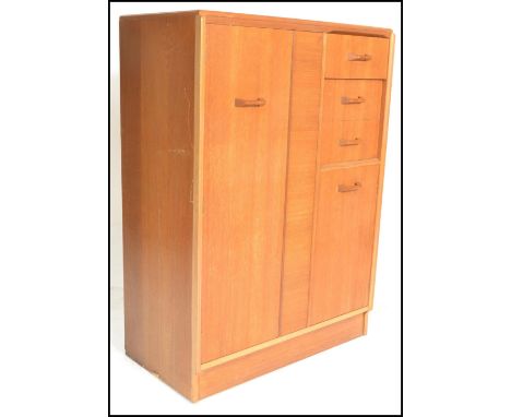 E. Gomme- G Plan- Brandon Range- A retro mid 20th Century light oak tallboy, with full length hanging cupboard to the left al