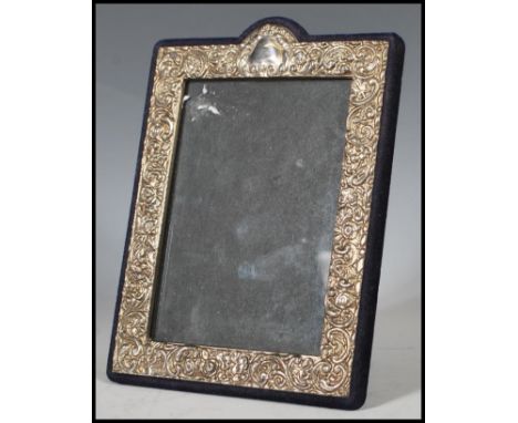 A continental silver easel back picture / photo&nbsp;frame having embossed Rococo influence scrolls and flower heads. Blue ve