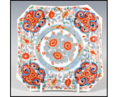 An 18th Century Chinese plate of octagonal form having hand painted floral decoration with a central cartouche of flower head