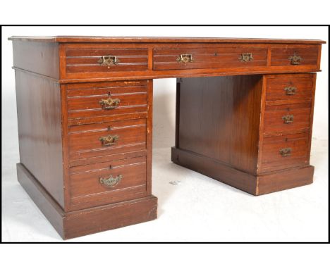A 20th Century Georgian style mahogany veneered kneehole twin pedestal writing desk with tooled inset leather writing surface
