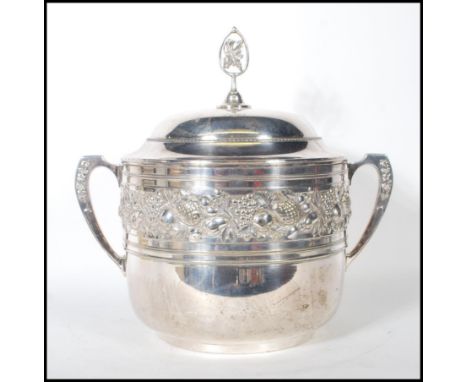 A 20th Century large German twin handled silver plated lidded punch bowl / ice bucket, decorated in relief with vines and fru