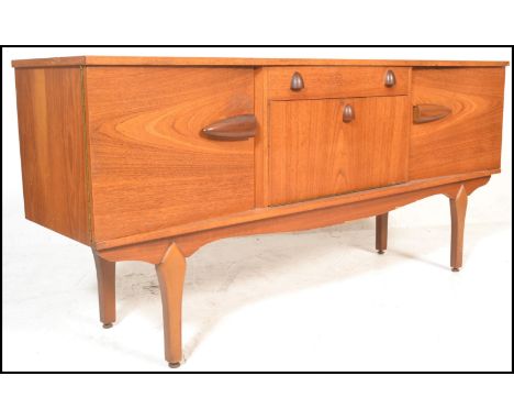 A vintage mid 20th century teak wood sideboard having a central drop down bar compartment with interior shelf with a drawer a