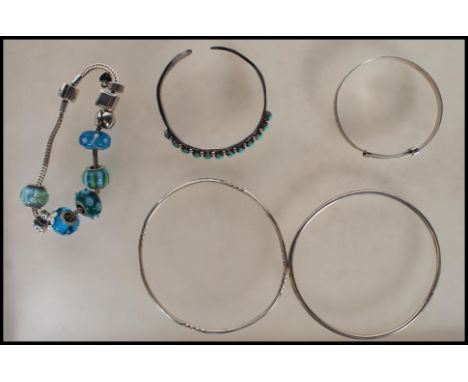 A selection of silver bracelets to include a bangle set with oval turquoise cabochons, a Rhona Sutton snake chain bracelet ha