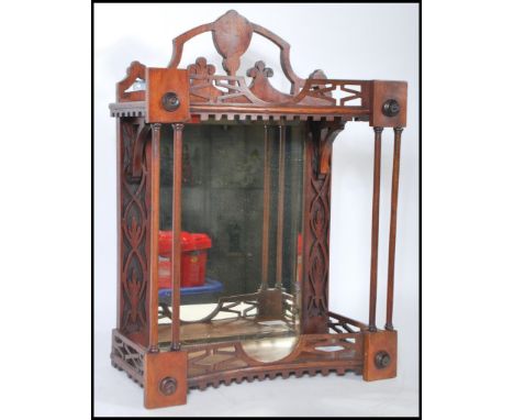 An early 20th Century wall mounted display cabinet being mahogany cased with pierced fretwork to the shelf and frieze with a 