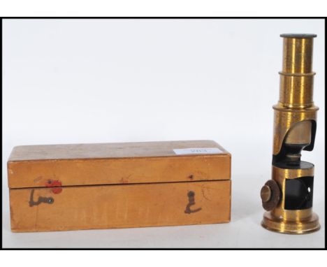 A late 19th Century brass students pocket cased microscope, adjuster to side fitted in a hinged wooden case.