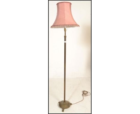 A 20th Century Corinthian column standard lamp raised on a circular base cast in relief with acanthus leaf design terminating