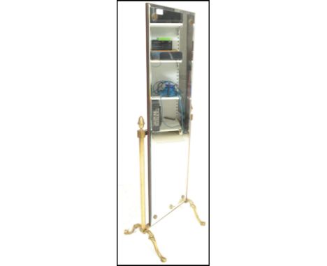 A mid 20th Century brass framed full size Cheval dressing bedroom mirror, raised on reeded column supports surmounted with fi