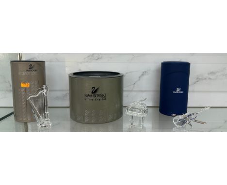 Three original boxed Swarovski instrument pieces to include ' Piano and Stool A7477 NR 000 006', ' Harp A7477 NR 000003' and 