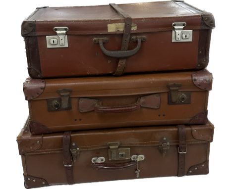 Three vintage trunks largest measures approximately 9 inches tall x 27 wide 