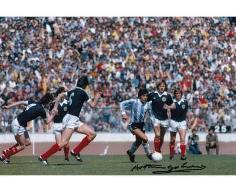 Autographed ARTHUR GRAHAM 12 x 8 photo : Col, depicting a superb image showing Argentina's Diego Maradona being surrounded by