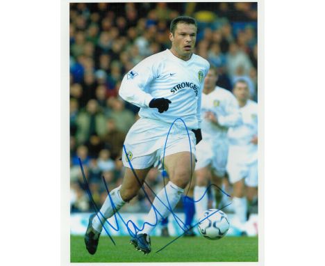 Mark Viduka signed 10x8 inch colour photo pictured in action for Leeds United. Good condition. All autographs come with a Cer