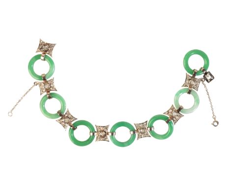 A BELLE ÉPOQUE JADE AND DIAMOND BRACELET&nbsp;in platinum, comprising a series of carved jadeite jade rings, alternating with