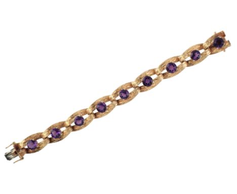 A VINTAGE AMETHYST BRACELETin 18ct gold, comprising a series of stylised textured links, each set with a round cut amethyst, 