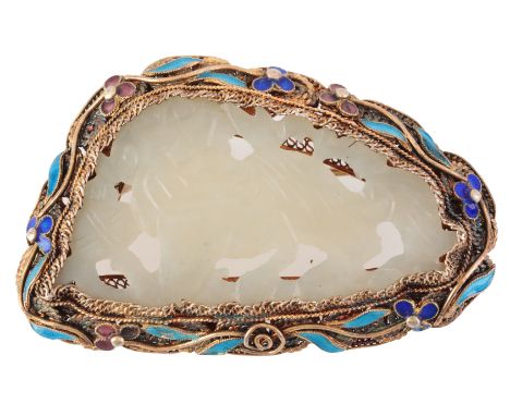 A JADE AND ENAMEL BROOCHin silver gilt, set with a carved jade tablet, held in a stylised mount with enamel detailing, secure