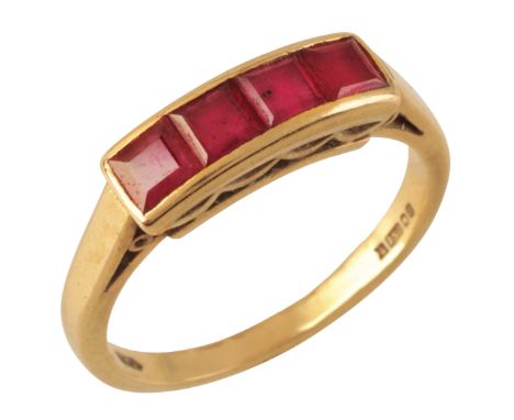 A RUBY DRESS RINGin 18ct gold, set with four step cut rubies held in a channel setting, full British hallmarks for London, 19