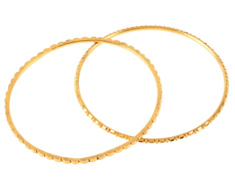 A PAIR OF GOLD BANGLESin high carat gold, with engine turned detail to the outside, no assay marks, internal circumference c.