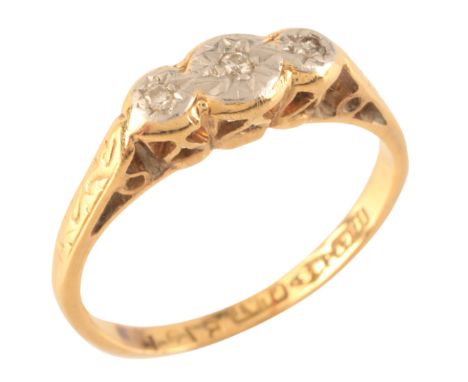 A DIAMOND THREE STONE RINGin 18ct gold, set with three single cut diamonds, stamped '18CT PLAT', size K / 50, (c.2.4g)