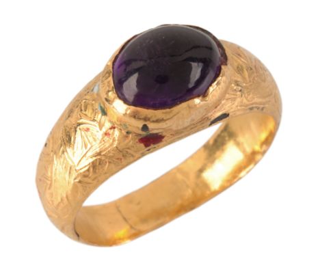 AN AMETHYST RINGin chased gold, set with an amethyst cabochon, the band with a design in relief, no assay marks, size P1/2 / 