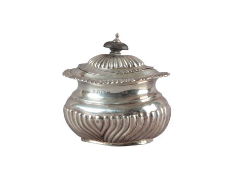 AN EDWARD VII SILVER OVAL TEA CADDYby William Adams, Birmingham 1902, of Georgian style, with fluted decoration to body shell