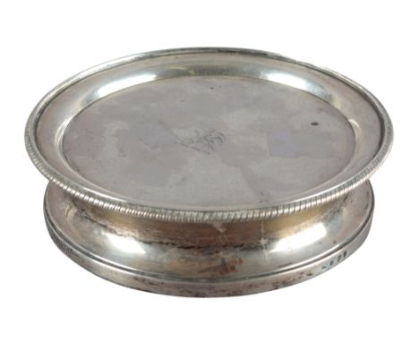 A GEORGE III SILVER WINE BOTTLE STAND OR COASTERattributed to Robert Garrard, London 1806, with gadrooned rim and incurved si