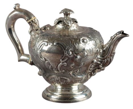 A VICTORIAN SILVER TEAPOT by Garrards & Co., London 1845, with floral finial, repousse bulbous body, on circular foot, 14.5cm
