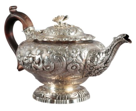 A GEORGE III SILVER TEAPOT by Craddock & Reid, London 1818, the squat bulbous body richly embossed with cherubs and grapes, f