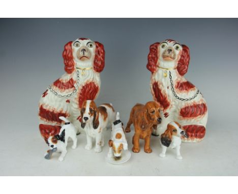 Three Royal Doulton models of dogs, comprising HN1158, 1036 and 1187, with a Ricado Studio model of a dog and a pair of Staff