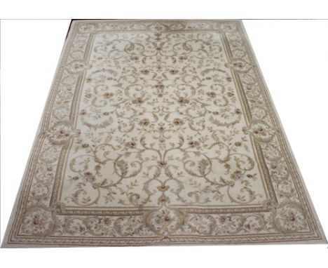 A machine woven carpet, worked with scrolling floral design against a cream ground, 240cm x 170cm