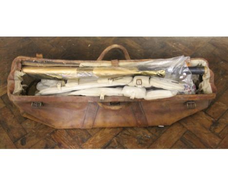 A vintage leather cricket bag containing a Gunn & Moore 'The Autograph' cricket bat and two pair of pads, and a Alibaba washi