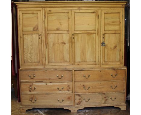 A Victorian and later pine housekeepers cupboard, with moulded cornice and four panelled doors, above six short drawers, on b