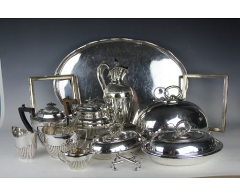 A selection of silver plated wares to include; a wine ewer with half wrythen decoration, a five piece tea service, a large ov