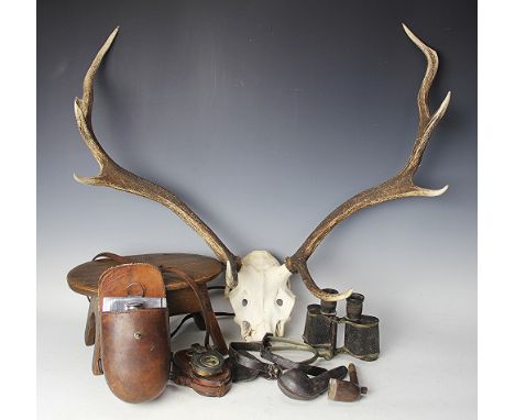 A taxidermy pair of eight prong antlers, 72cm, with an oak oval stool, WWI military compass in leather case, Edwardian huntin