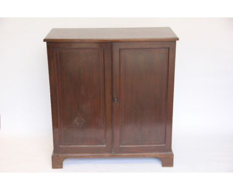 An Edwardian inlaid mahogany cupboard, with two short doors enclosing adjustable shelves, on bracket feet, 99cm H x 92cm W x 